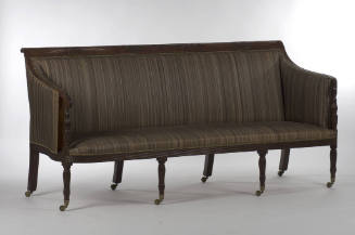 A Federal-style mahogany sofa on reeded legs and arms carved with acanthus leaves. The three pa…