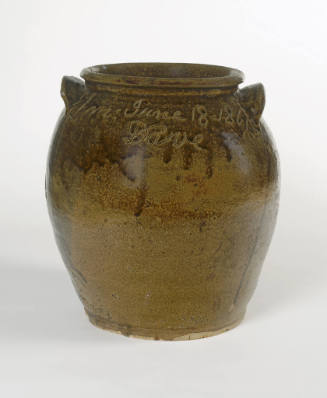 A double-handled dark brown glazed earthenware jar with a wide, rolled rim and squat body with …