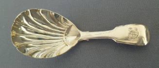 A Georgian sterling silver tea caddy spoon with fluted bowl and fiddle pattern handle.