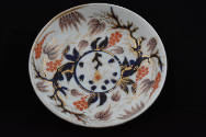 One of eight saucers from a twenty-one-piece tea service characterized by a tree and its base l…