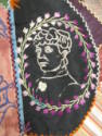 A detail of a patch with a profile of a woman. 
