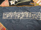 A detail of a patch with music notes. 