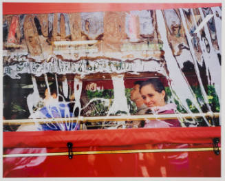 A photograph of tourists seated behind the red siding and plastic window covers on a Savannah t…