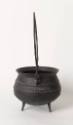 The side of a cast iron, three-legged pot or cauldron with a tall handle, flared lip and narrow…