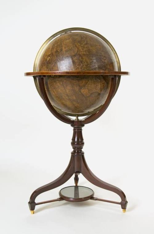 A mahogany tripod stand with circular support for a terrestrial globe created out of boxwood an…