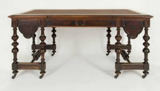 A Victorian walnut library table with leather-paneled top and curved-molding drawer fronts bene…